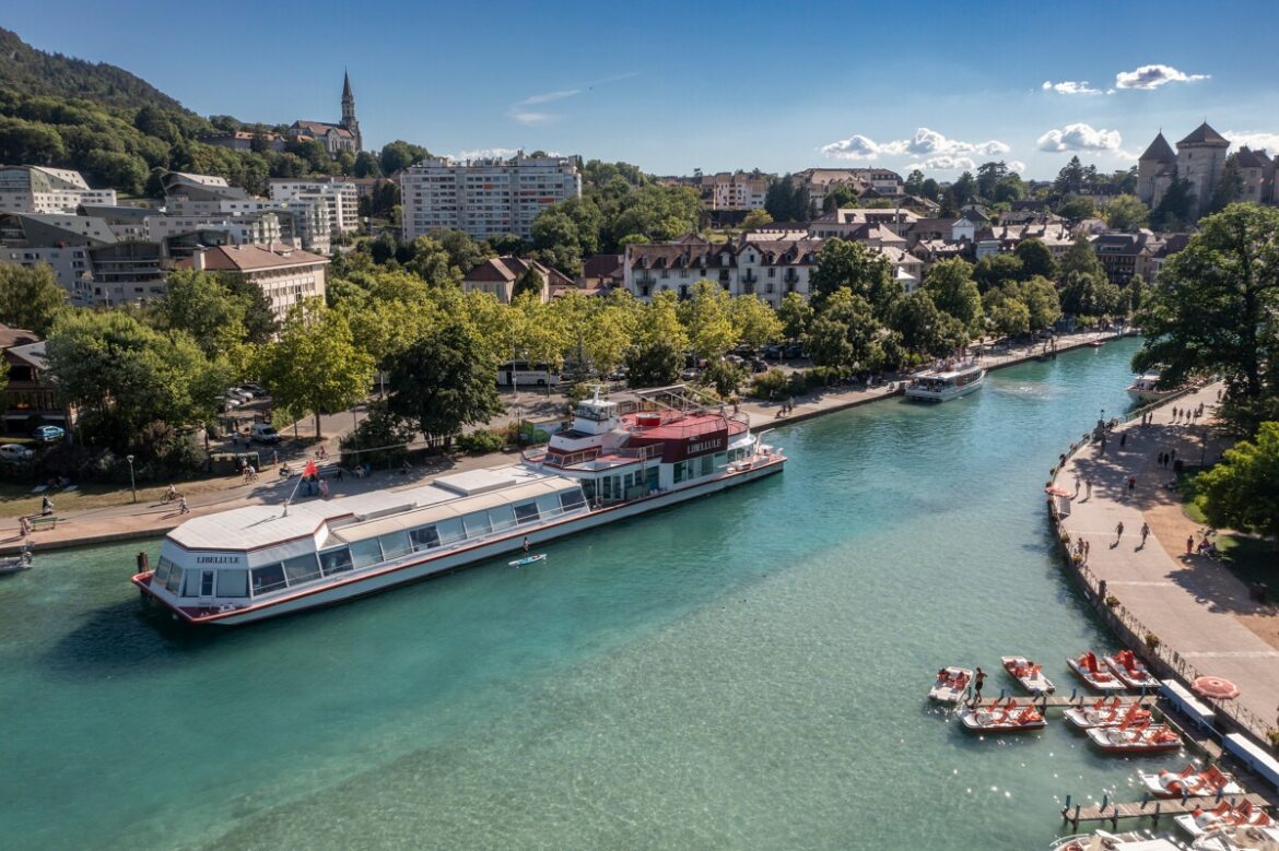Aerial view of the Canal du Vasse in Annecy, lined with trees and old buildings
